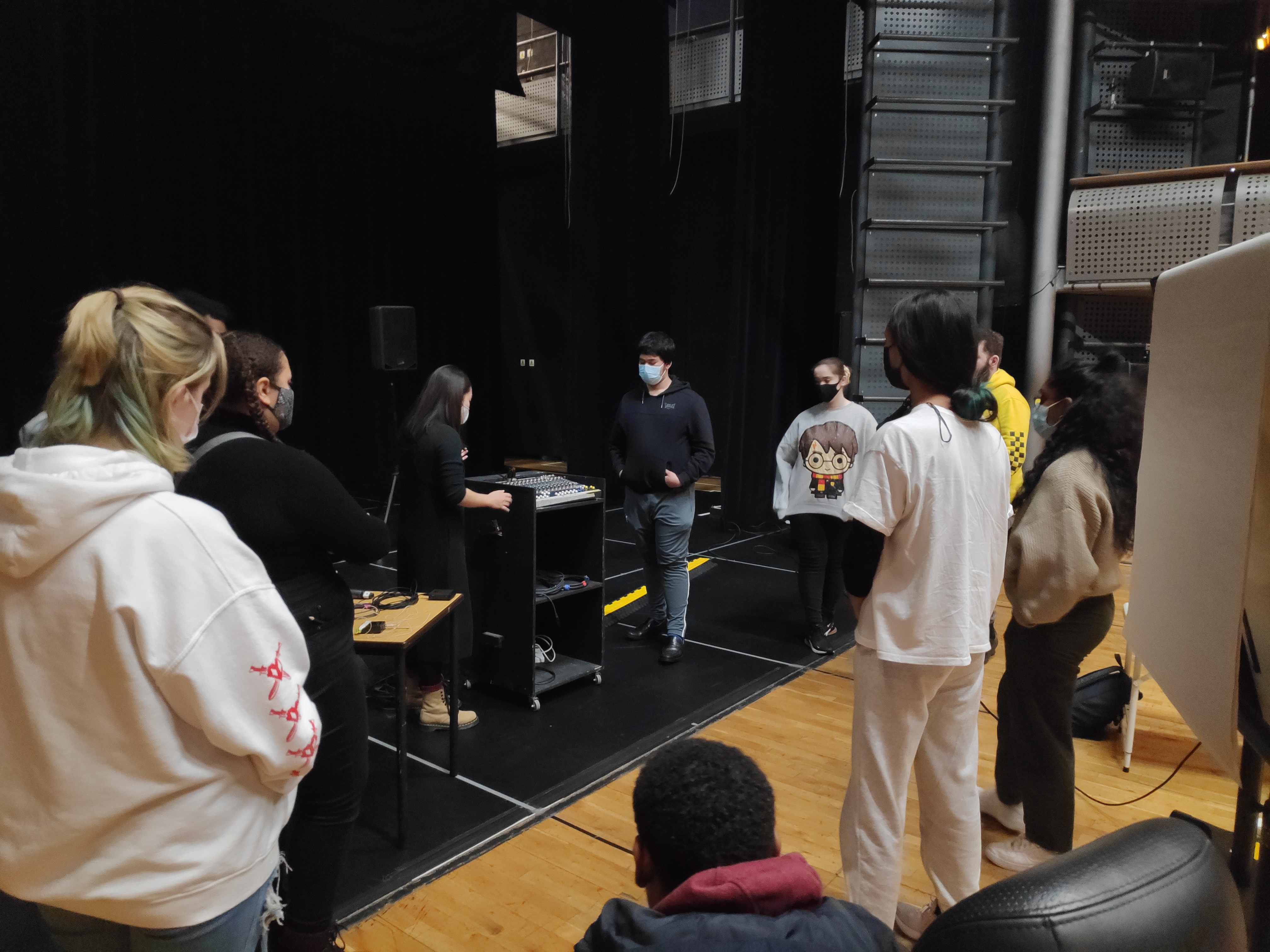 Group of Young Technicians standing around a speaker